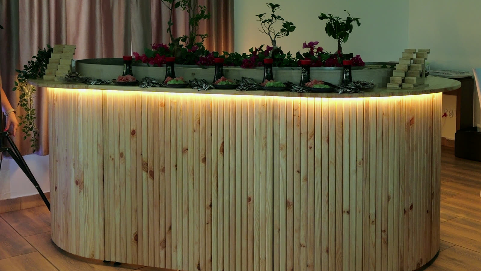 The finished table glowing warm in an evening hall