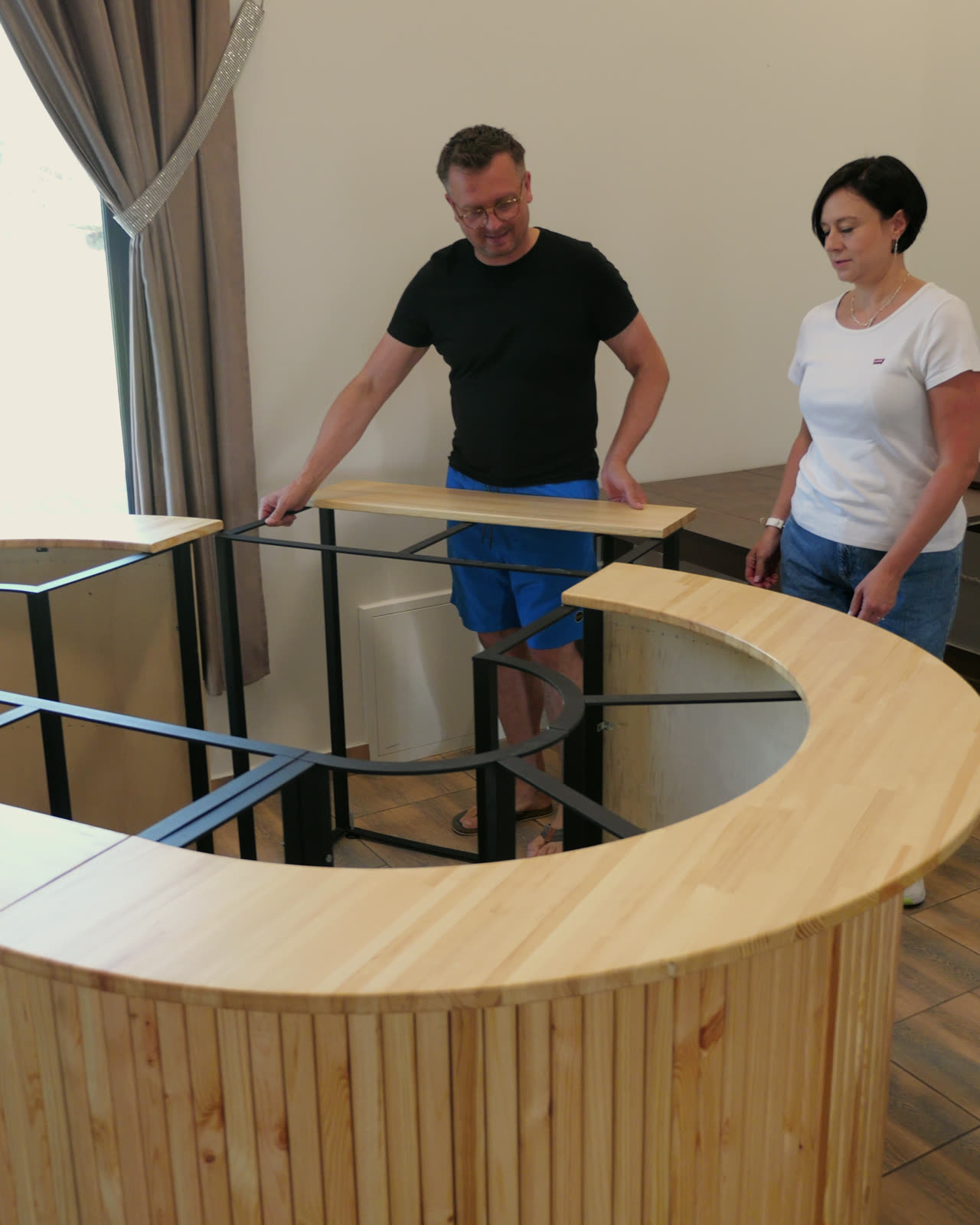 Tomek and Ania assembling the table's modules at a venue