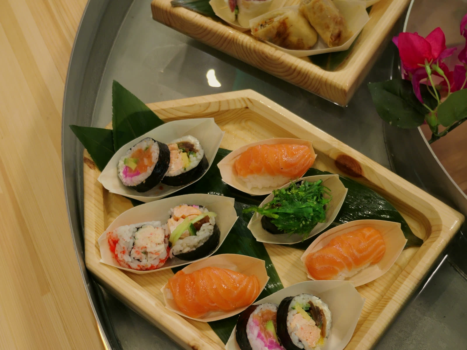 Boats of nigiri and maki on a floating tray